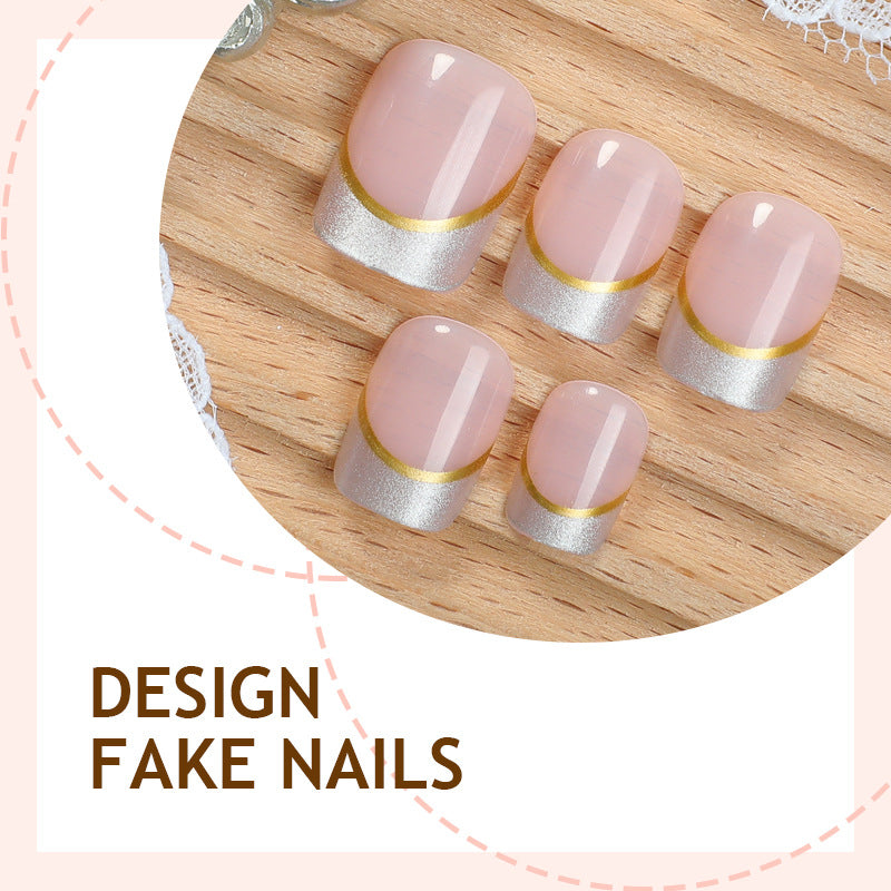 Artificial nail creations with elegant gold trim Bowlift