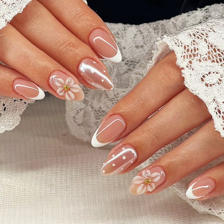 Artificial nail set with elegant French tips and delicate floral accents Bowlift