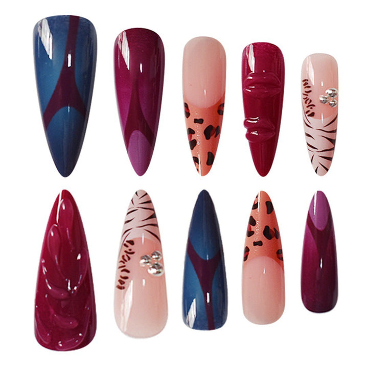 Artistic Stiletto Nail Enhancements with Trendy Animal Print and Gem Accents Bowlift