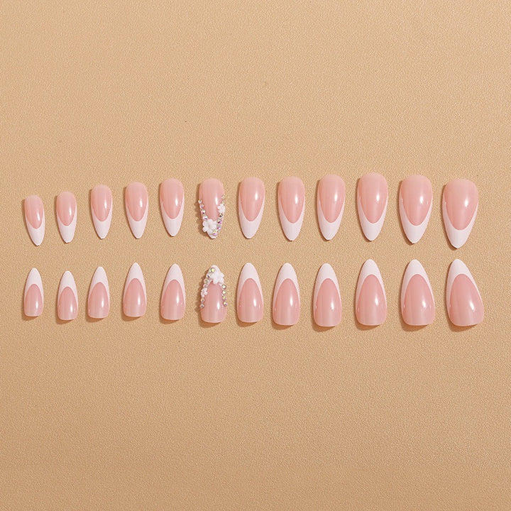 Artificial nails with elegant French tips and rhinestone details Bowlift