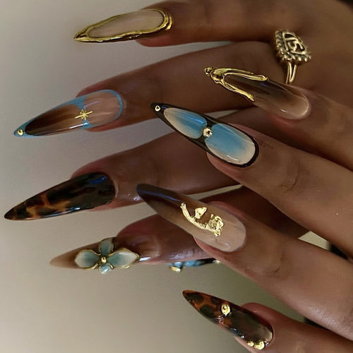 Artificial nail set with luxurious gold design and floral accents Bowlift