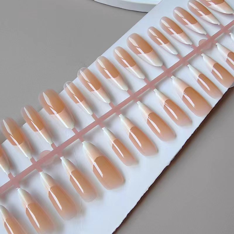 Artificial nails in the elegant French tip design Bowlift