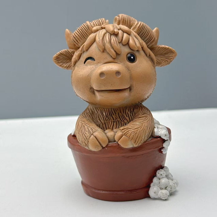 Funny decorative figure of a Highland cow on toilet Bowlift