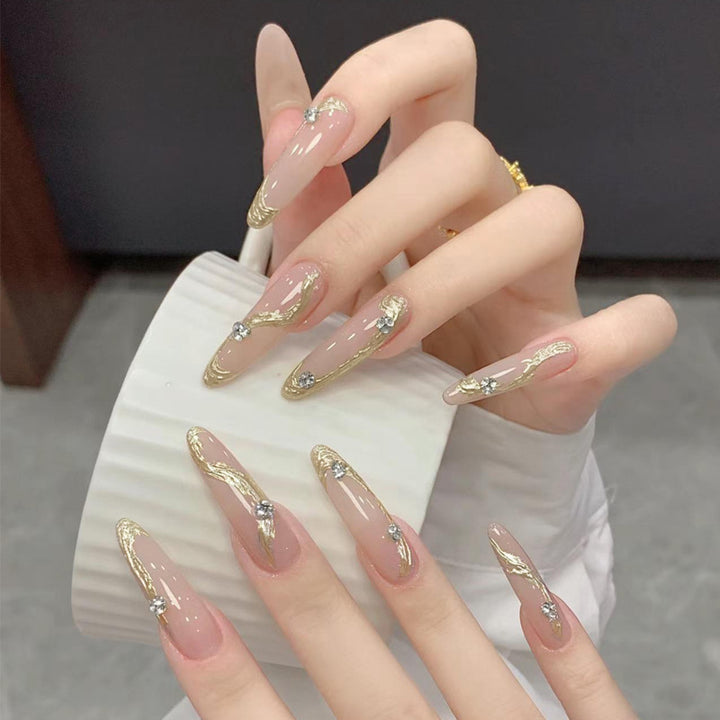 Artificial nail set with elegant gold design and sparkling applications Bowlift