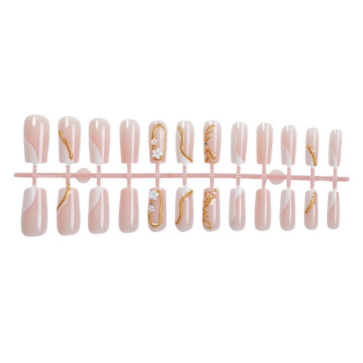 Elegant artificial nail set with golden accents and floral details Bowlift