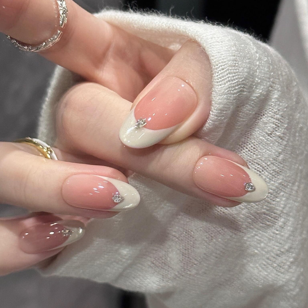 Artificial nails with elegant French style and sparkling accents Bowlift
