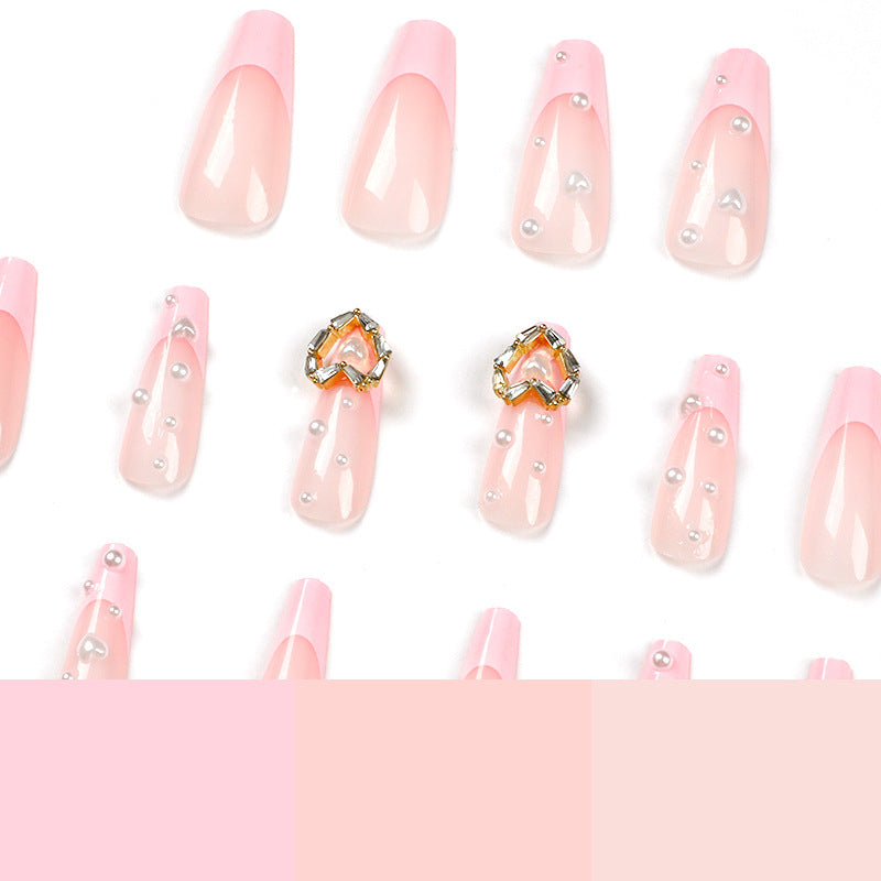 Artistic nail art with heart and pearl accents Bowlift