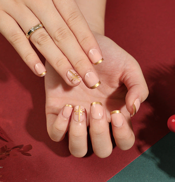 Elegant artificial nails with golden accents and floral design Bowlift