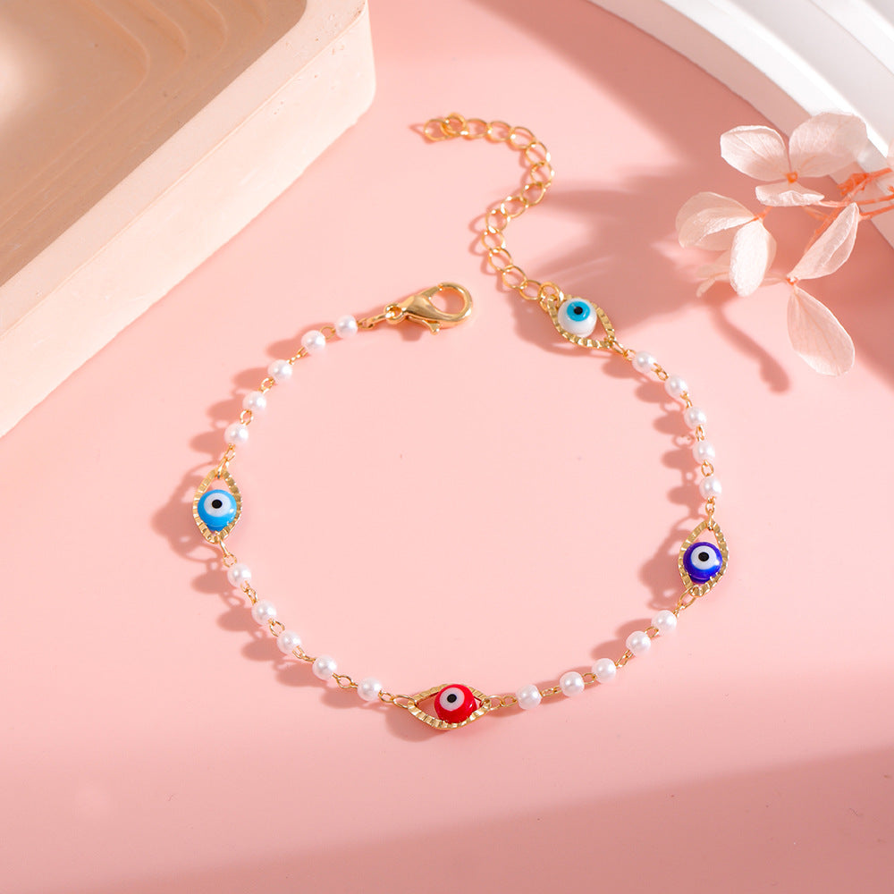 Elegant Pearl and Eye Charm Necklace Bowlift