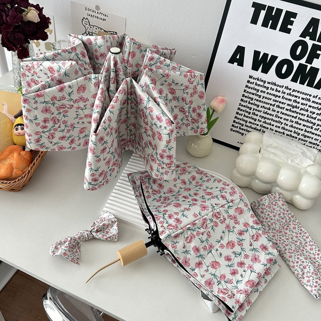 Women's folding umbrella with floral design and practical storage system Bowlift