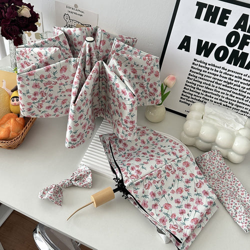 Women's folding umbrella with floral design and practical storage system Bowlift