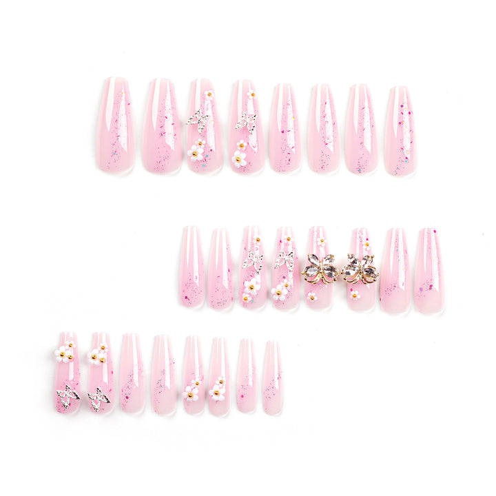 Artistic Nail Extensions with Glitter and Floral Accents Bowlift
