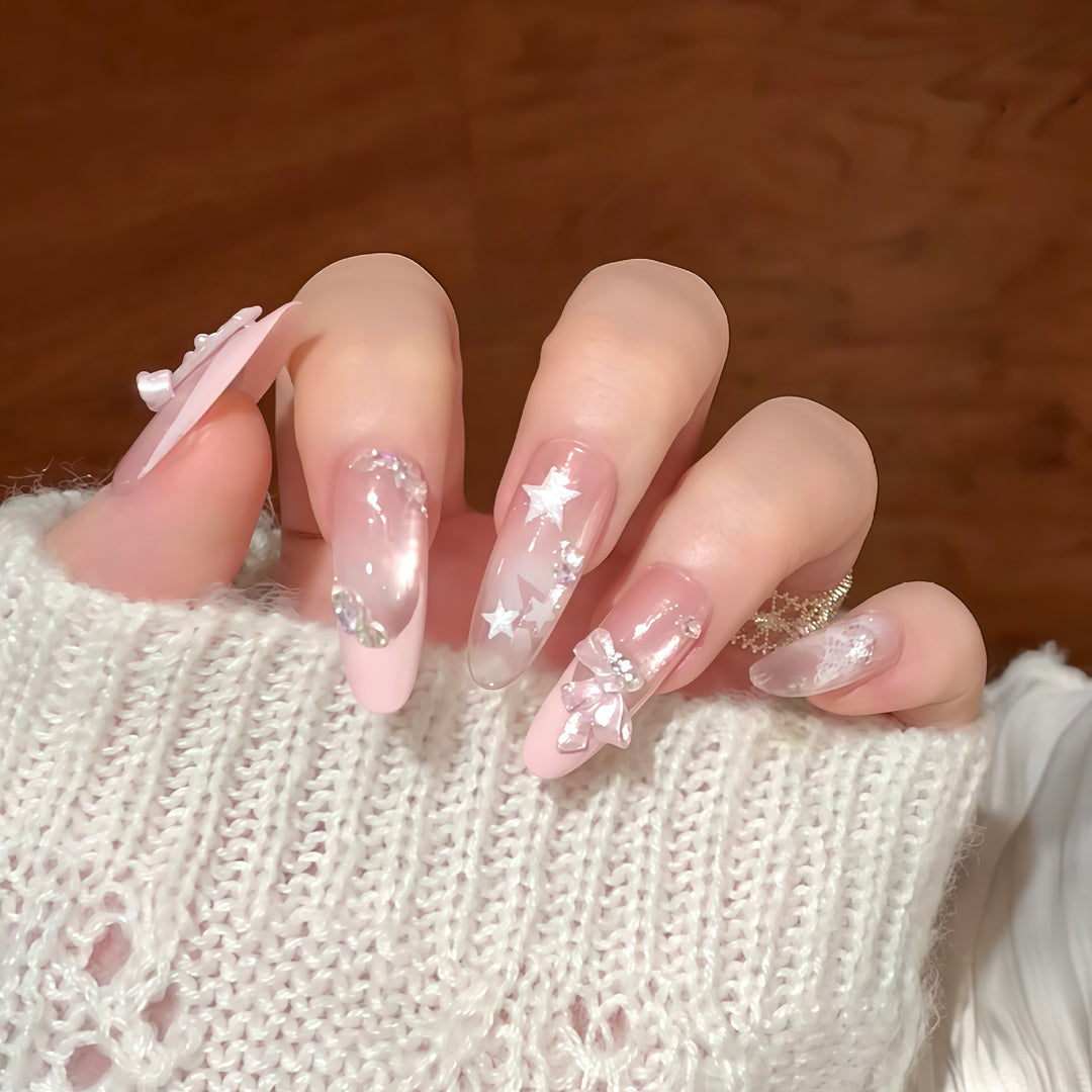 Artificial nail tips with glamorous glitter and bow details Bowlift