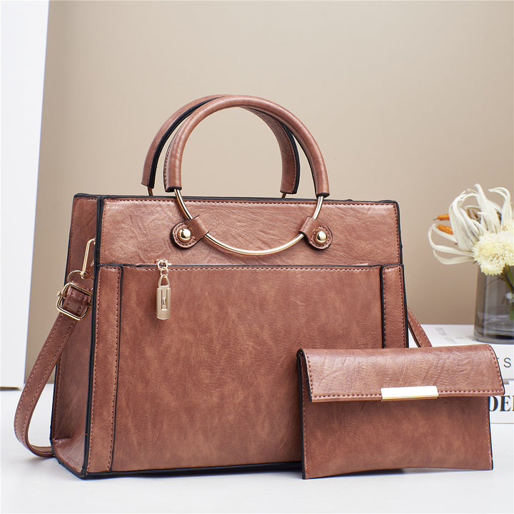 Elegant handbag with detachable shoulder strap and matching wallet Bowlift