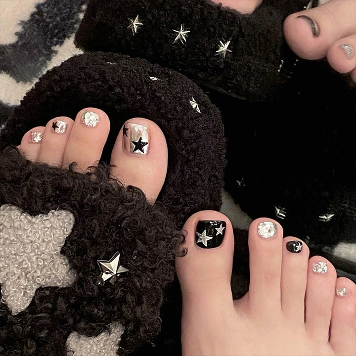 Artistic toenail art with rhinestone and glitter elements Bowlift