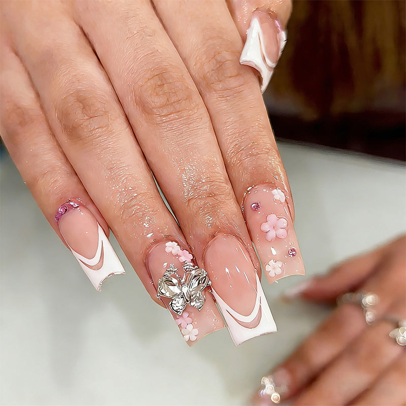 Artificial nails with floral accents and glitter effects Bowlift