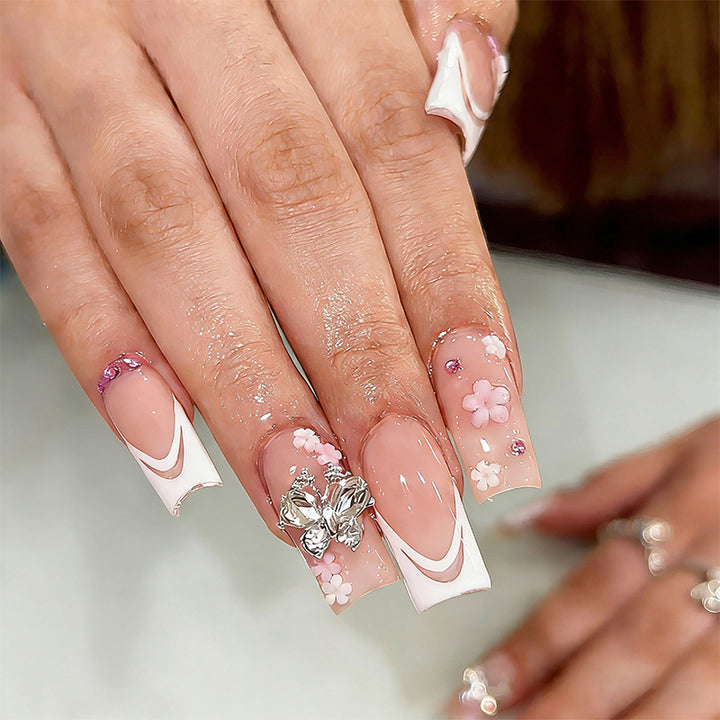 Artificial nails with floral accents and glitter effects Bowlift