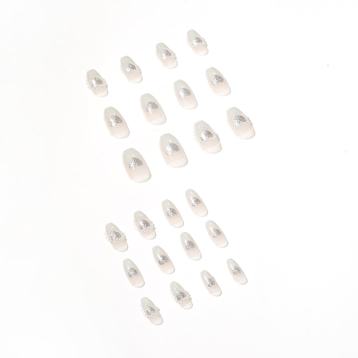 Artificial nail art with heart and rhinestone decorations Bowlift