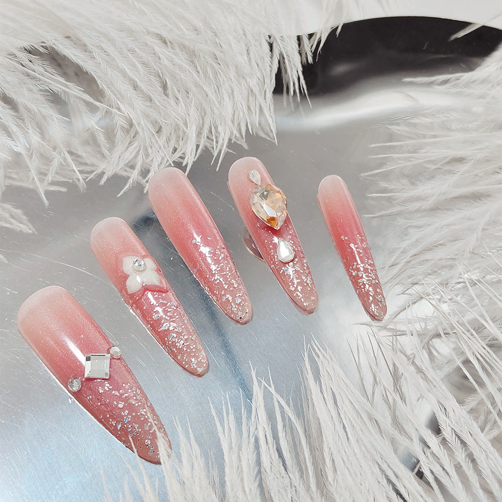 Artificial nail set with glitter and flower accents Bowlift