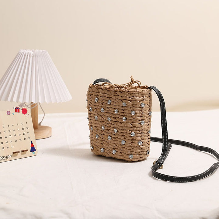 Bag made of woven natural material with sparkling appliqués Bowlift