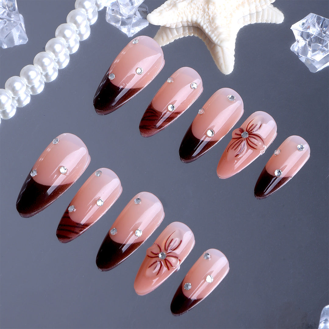 Artificial nails with elegant flower design and glitter accents Bowlift