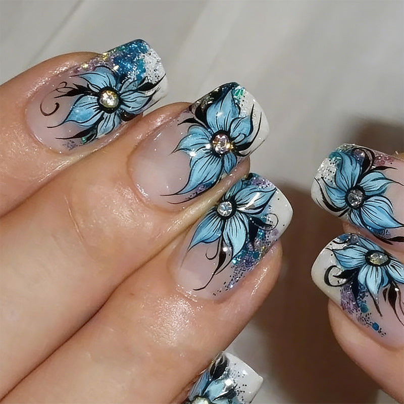 Artificial nail set with intricate floral designs and glitter elements Bowlift
