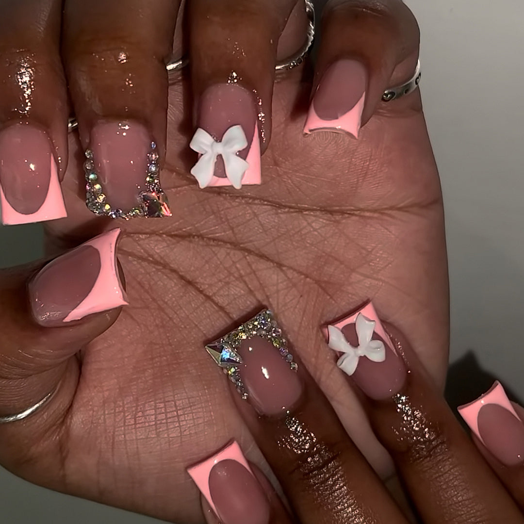 Decorative Acrylic Nail Enhancements with Bow and Rhinestone Accents Bowlift