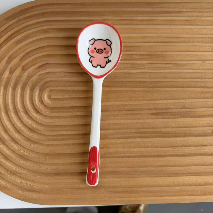 Ceramic soup spoon with lucky cat illustration and ergonomic long-handle Bowlift