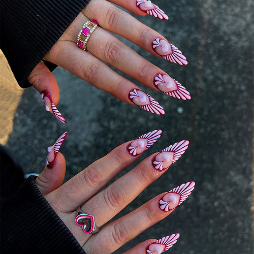 Artificial nails with playful heart design and elegant accents Bowlift