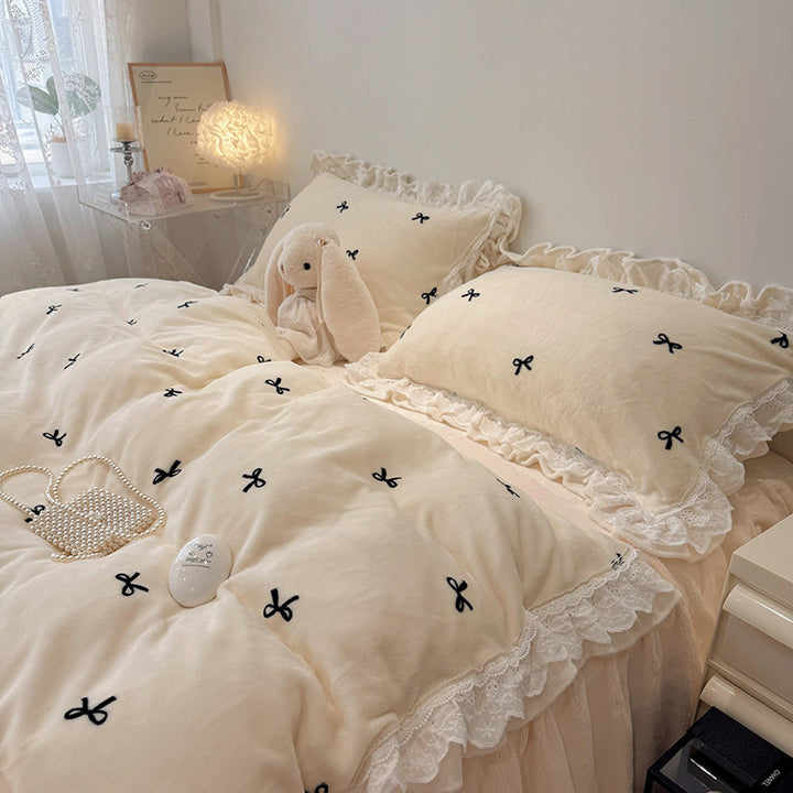 Bedding set with ruffled border and embroidered bows