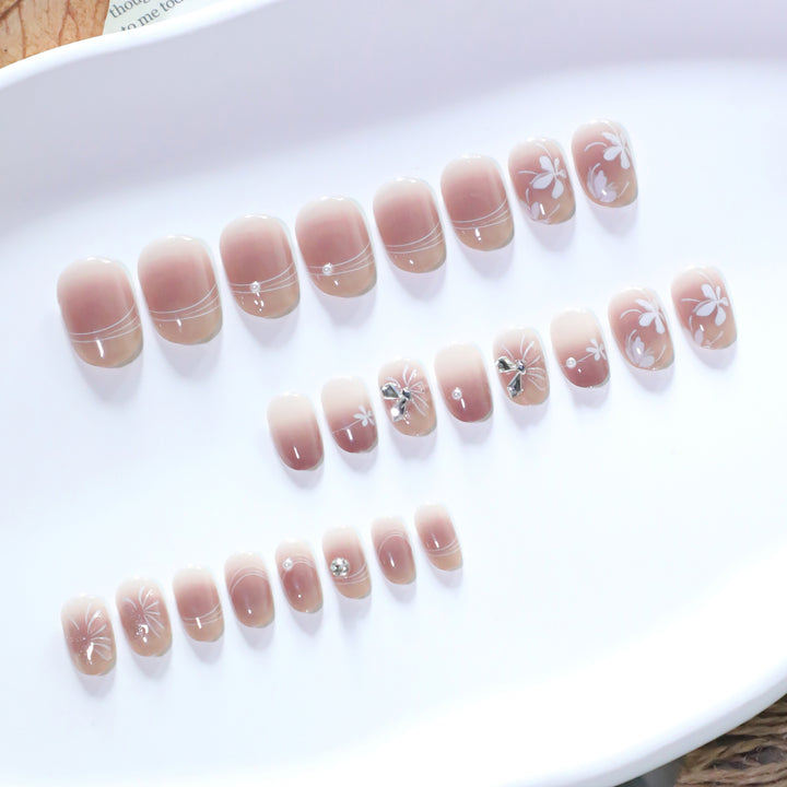 Artful nail design with floral pattern and glitter accents Bowlift