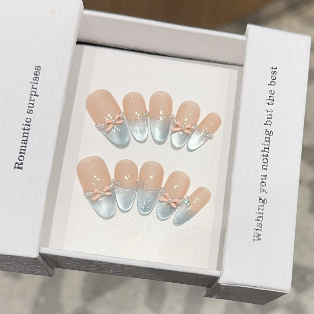 Artificial nail set with romantic bow and glitter accents Bowlift