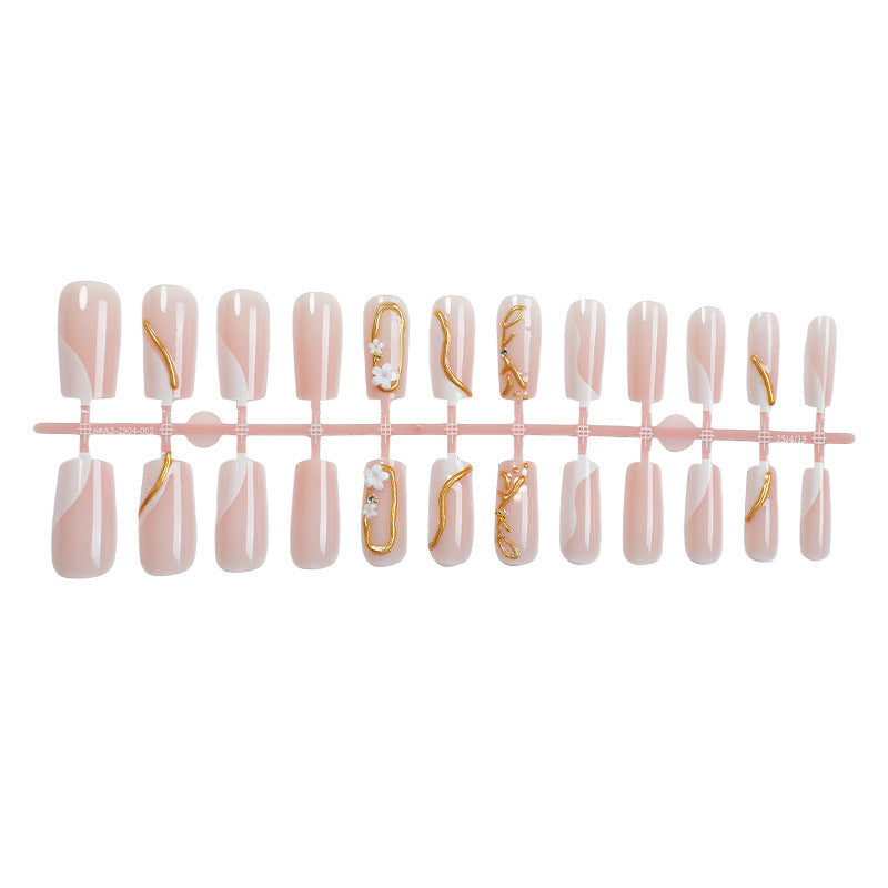 Elegant artificial nail set with golden accents and floral details Bowlift