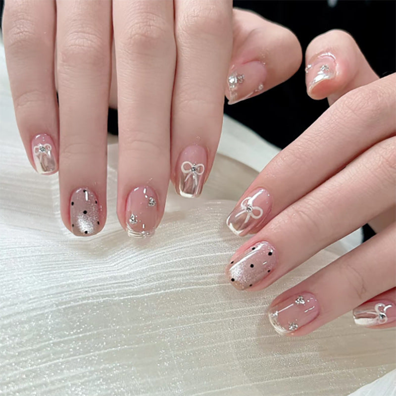 Artistic Nail Art with Bow and Glitter Accents Bowlift