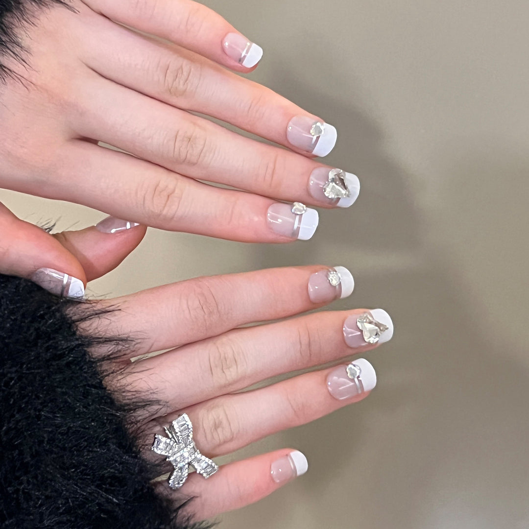 Elegant Nail Art with Glitter Accents and Jewelry Details Bowlift