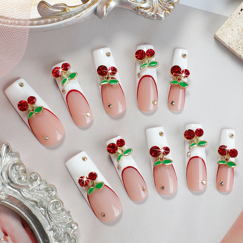 Artificial nail set with cherry motif and sparkling rhinestones Bowlift