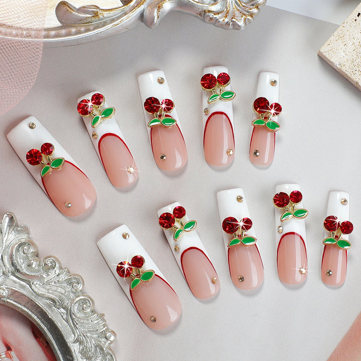 Artificial nail set with cherry motif and sparkling rhinestones Bowlift