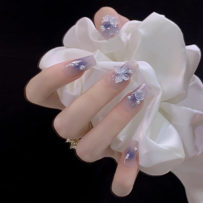 Artistic acrylic nails with butterfly design and glitter accents Bowlift