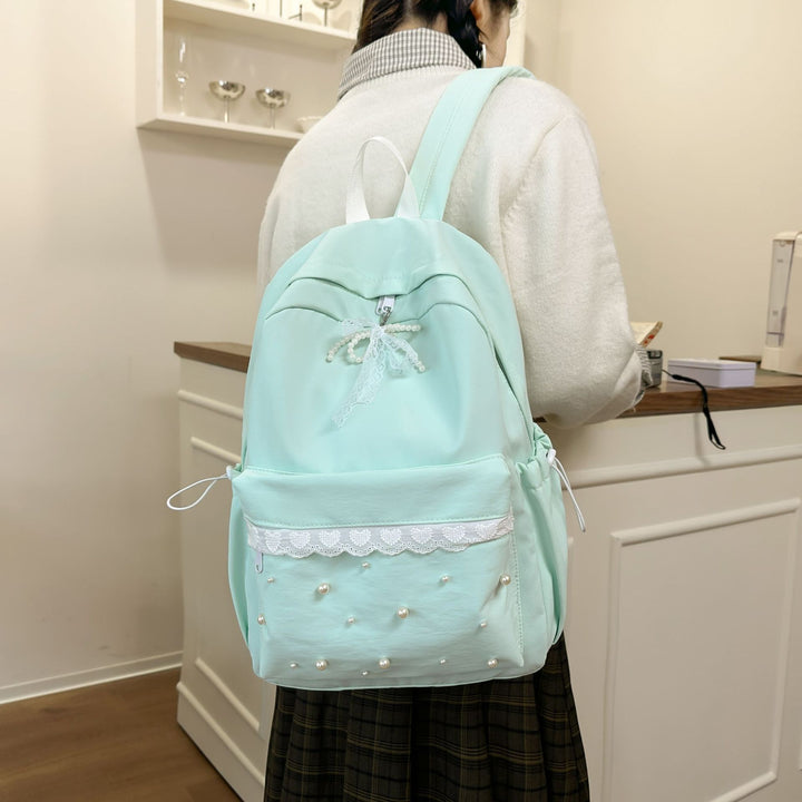 Backpack with elegant pearl applications and intricate design Bowlift