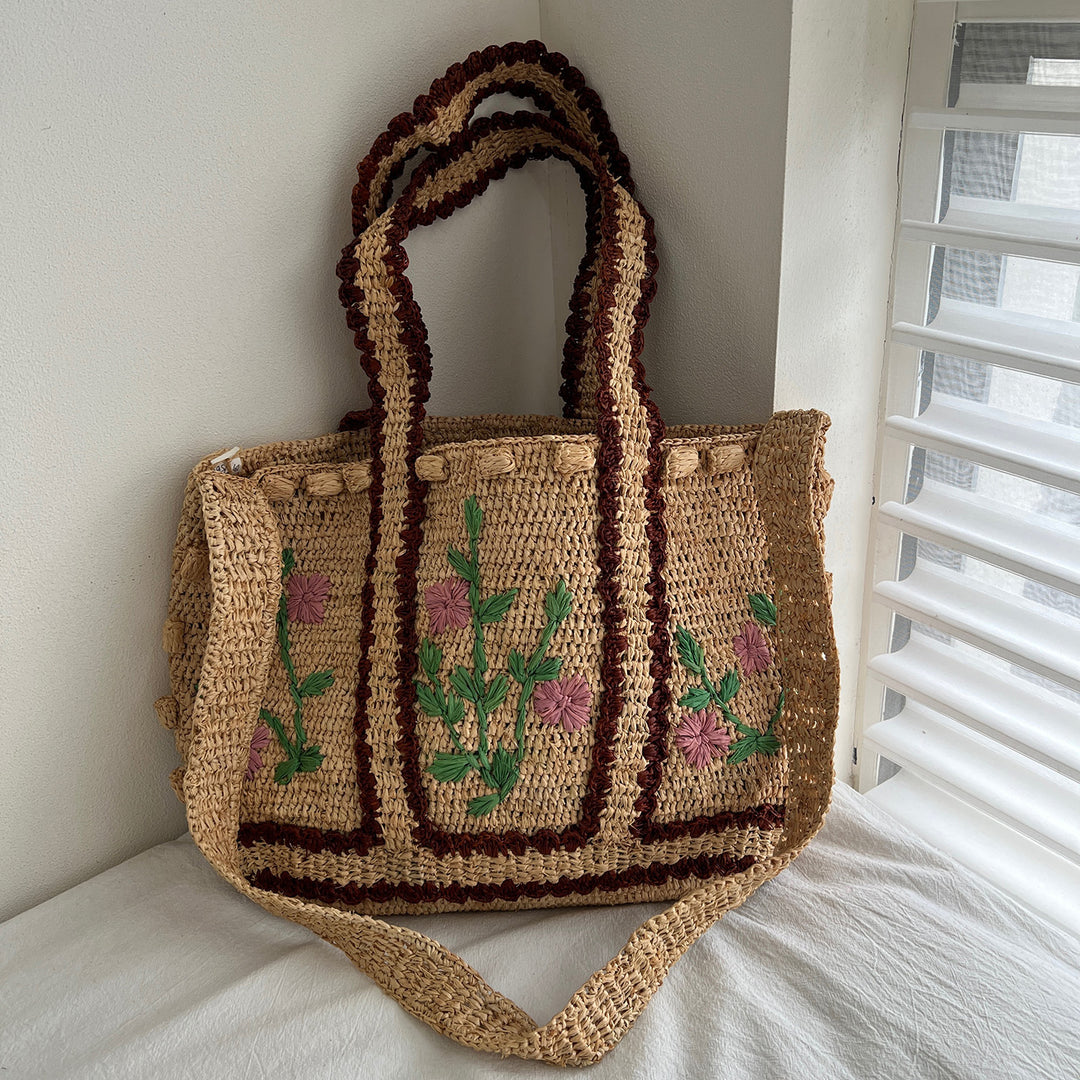 Braided shoulder bag with floral motif Bowlift