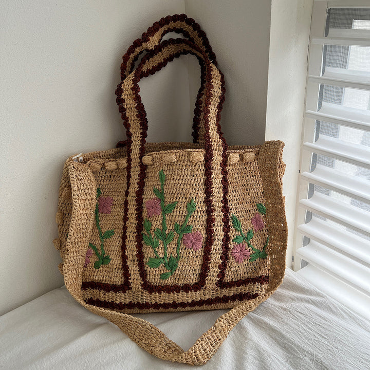 Braided shoulder bag with floral motif Bowlift