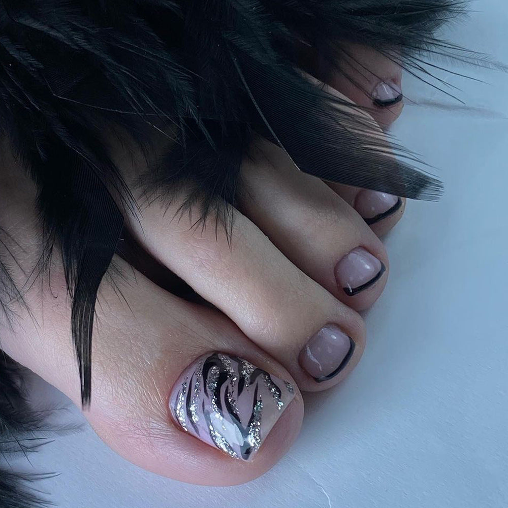 Artificial toenail art in elegant black and white design Bowlift