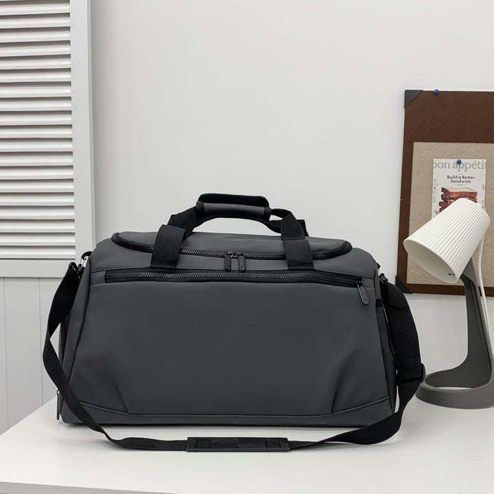 Sporty travel bag with reinforced carrying handles and multiple compartments Bowlift