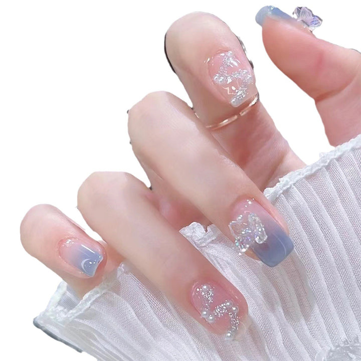 Artistic nail decoration with glitter and butterfly details Bowlift