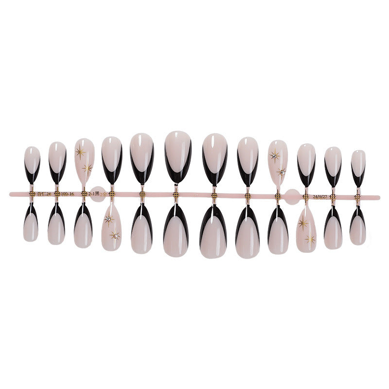 Artificial nail set with elegant black-and-white design and golden star accents Bowlift