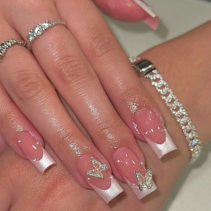 Nail art set with intricate designs and butterfly appliqués Bowlift