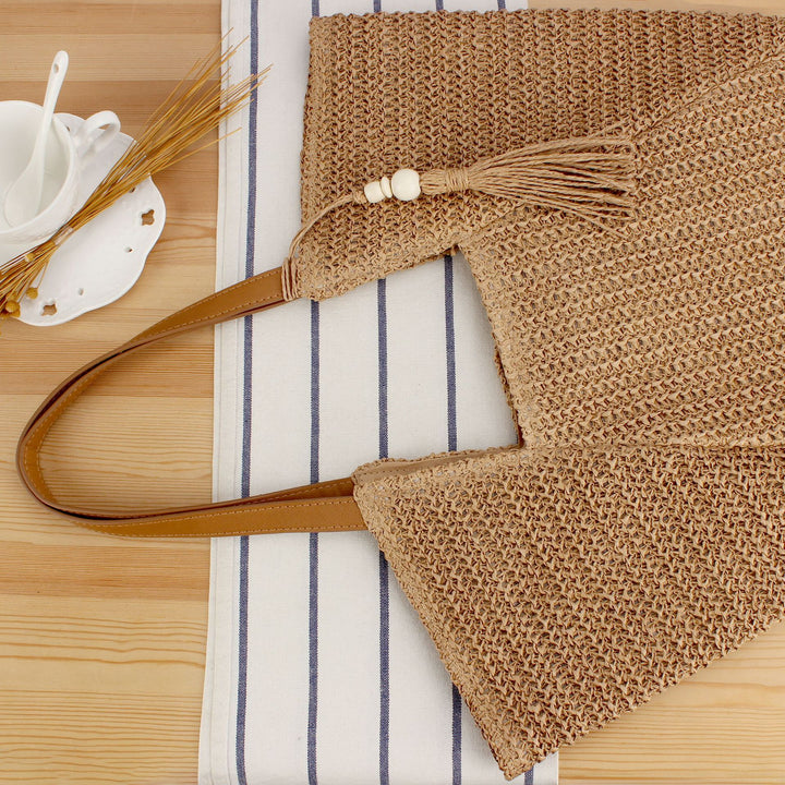 Beach bag made of natural weave with elegant leather accents Bowlift