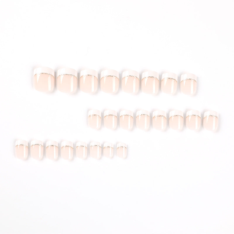 Artful nail extensions with elegant French tip and gold accents Bowlift