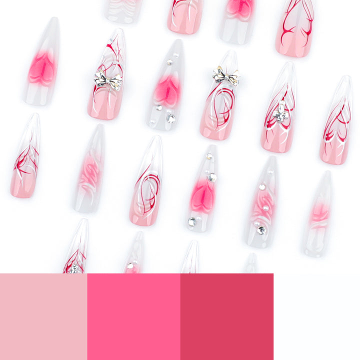 Artful stiletto nails with elegant floral accents and glitter embellishments Bowlift