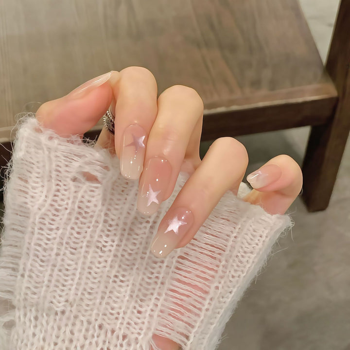 Artificial nails with sparkling stars and gentle gradient Bowlift